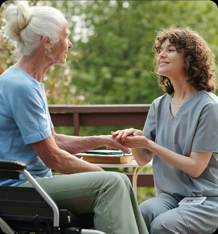 Two women talking together outside on a porch