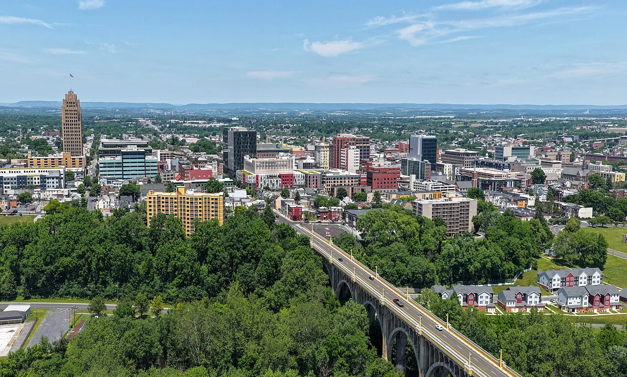 Aerial view of downtown Allentown, Pennsylvania, with its skyline, trees, and arched bridge.