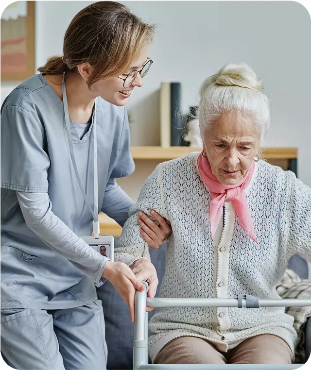 A caregiver helping a woman stay active and independent