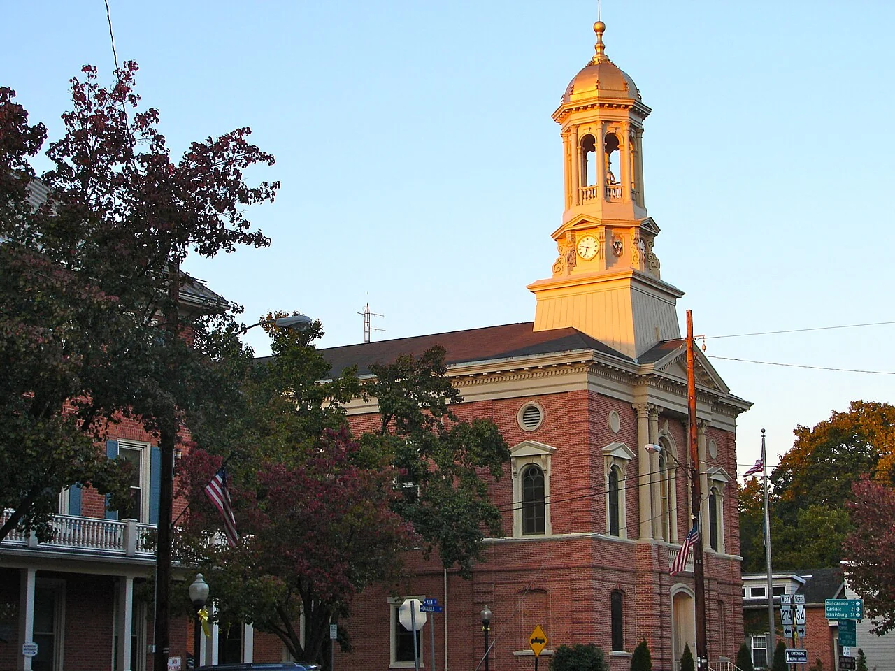 Perry County Courthouse in New Bloomfield, Pennsylvania, with its clock tower lit by the sun.